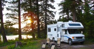 RV and chairs at secluded campsite at sunset