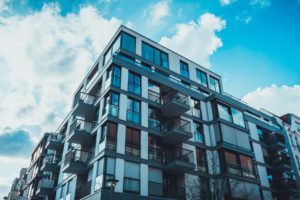 Low angle view of glass windows on condominium apartments