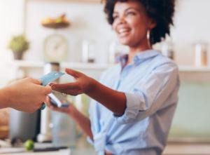 female employee taking payment from customer,
