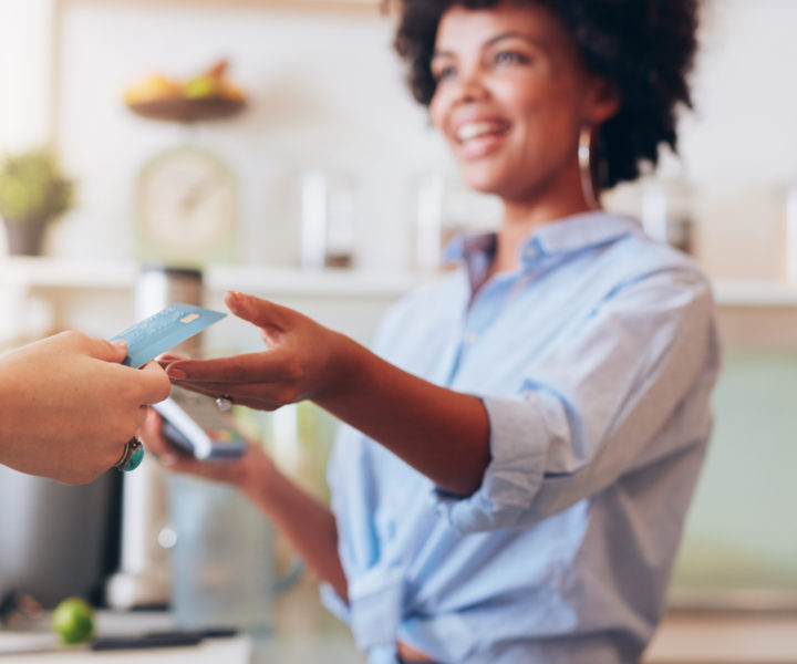 female employee taking payment from customer,