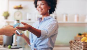 female employee taking payment from customer,