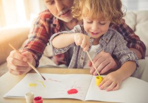 Handsome grandpa and grandson are painting