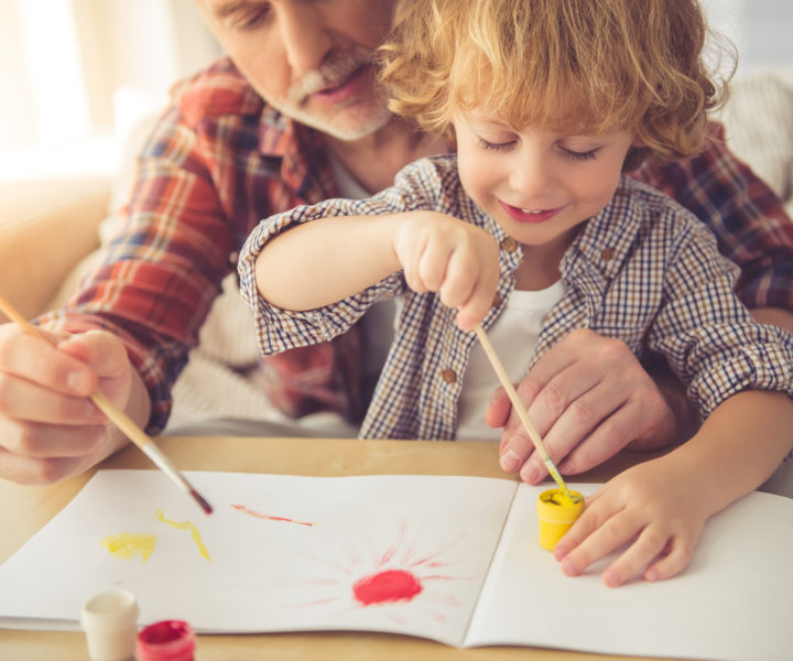 Handsome grandpa and grandson are painting